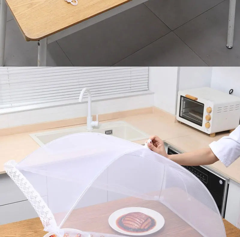 A white foldable mesh insect and fly protection cover is placed over a plate on a wooden table.