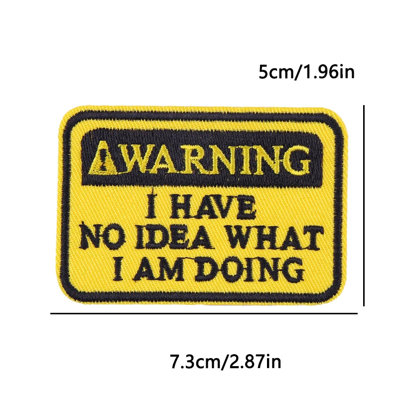 Yellow embroidery patch with black text warning I have no idea what I am doing
