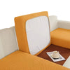 A yellow textured cushion cover on a white sofa seat, featuring a white pillow.