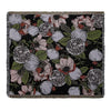 A dark floral pattern throw blanket featuring pink, white, and green botanical designs.