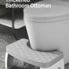 A white thickened bathroom ottoman or toilet pad used as a stool for comfort.