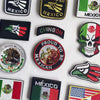 A collection of tactical patches featuring the Mexican flag, eagle, and skull design.