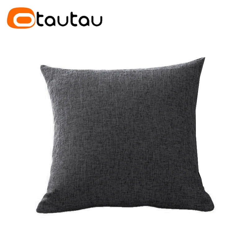A dark gray linen cushion cover with a button closure.