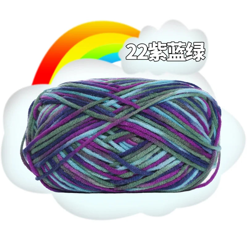 A ball of purple and green yarn is shown inside a white cloud with a rainbow in the background.