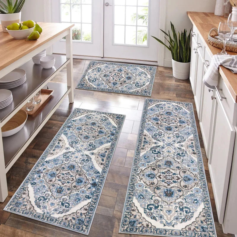 A set of blue and white patterned bohemian anti-slip floor rugs laid out on a wooden floor.