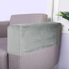A light green velvet armrest cover placed on a mauve sofa.