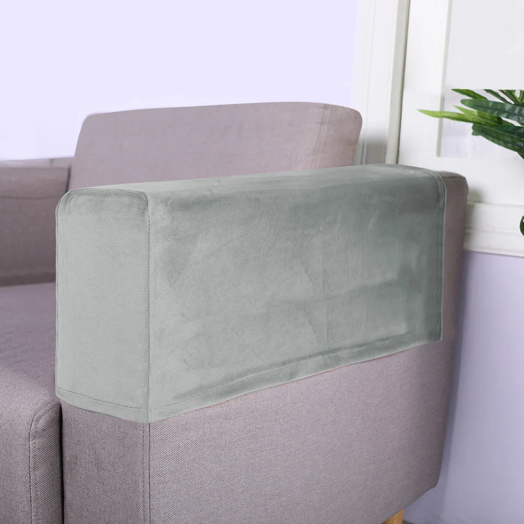 A light green velvet armrest cover placed on a mauve sofa.