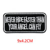 Black embroidered letter patch with white text that reads Never ride faster than your angel can fly