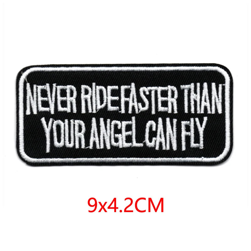 Black embroidered letter patch with white text that reads Never ride faster than your angel can fly