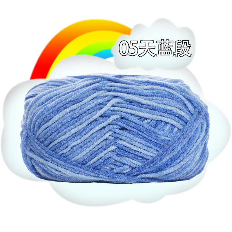 A ball of blue yarn is shown inside a white cloud, with a rainbow in the background.