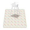 A white plastic baby play mat with a colorful dinosaur pattern and anti-slip backing.