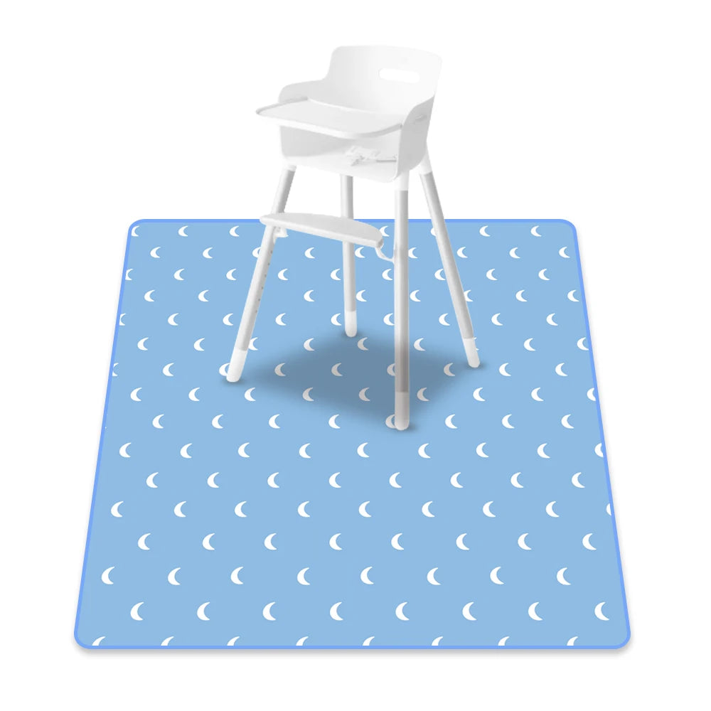 A white baby play mat with a wooden stool placed on it, featuring a light blue pattern of crescent moons.