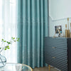 Light blue curtains featuring a white silhouette of trees against a pale background.