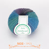 A ball of multi-colored Australian wool yarn with shades of blue, green, and purple.