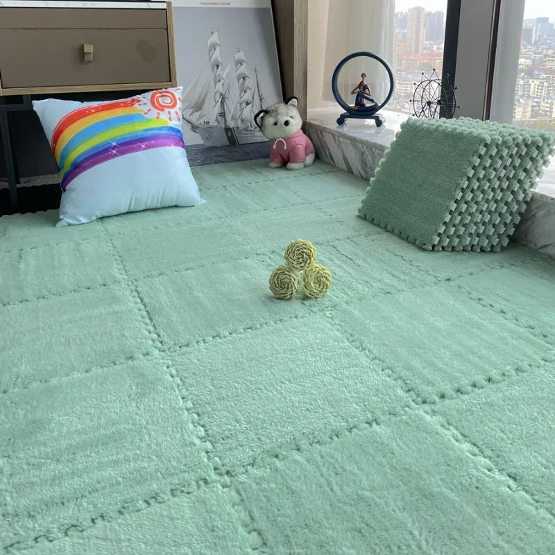 A light green plush interlocking puzzle rug mat with various textured cushions and a stuffed animal on a wooden floor.