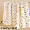 A cream colored double layer thickening baby swaddle blanket hanging on a wooden rod.