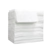 A stack of white disposable non-woven beauty and salon sheets.