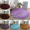 A collection of shaggy round area rugs in various colors including purple, brown, blue, and tan.