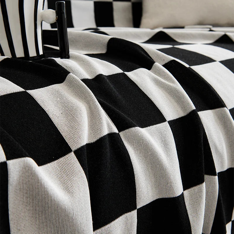 A black and white checkerboard fabric slipcover draped over a piece of furniture.