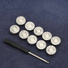 A black adjustable metal snap button with multiple silver buttons arranged on a dark blue fabric.