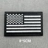 Black flag patch featuring a white American flag design with hook and loop backing