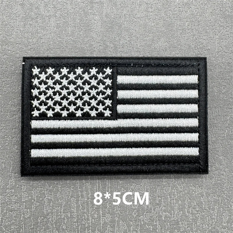 Black flag patch featuring a white American flag design with hook and loop backing