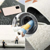 A close-up view of a phone and a cleaning tool inside a soft imitation cashmere foot mat.