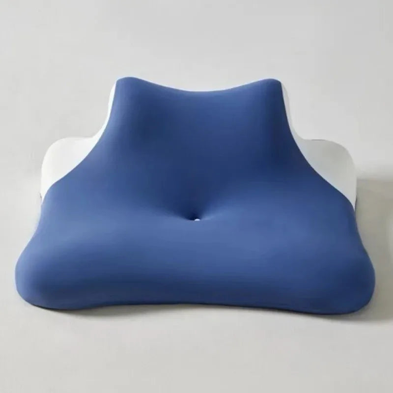 A navy blue ergonomic wedge pillow with a white trim, shown from the side.