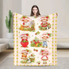 A plush throw blanket featuring a strawberry shortcake theme with illustrations of characters and fruit.