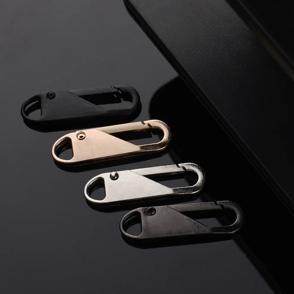 A collection of various metal and plastic zipper slider puller repair tools displayed against a dark background.