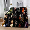 A dark, retro printed flannel throw blanket featuring a collage of faces and vibrant colors.