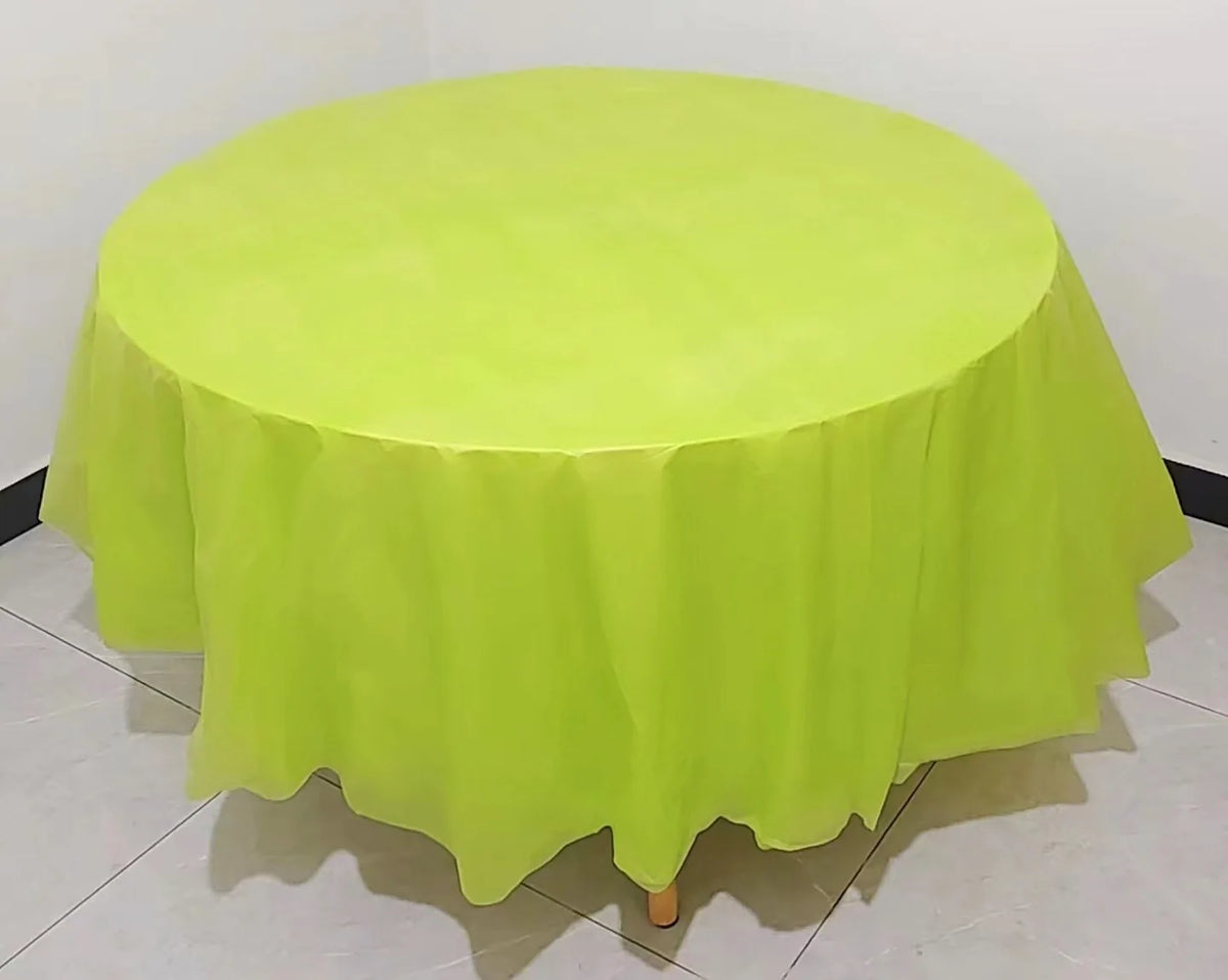 A round lime green plastic disposable table cover spread on a white surface.