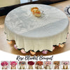 A hand knitted floral rose bouquet throw blanket displayed on a round table.