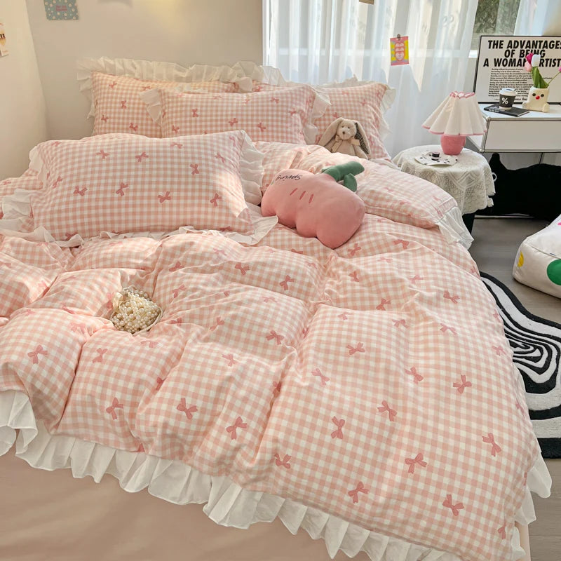 A pink floral bowknot duvet cover set displayed on a bed with white and cream bedding.