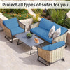 Blue outdoor sofa cushion covers protecting wicker sofas in a garden setting.
