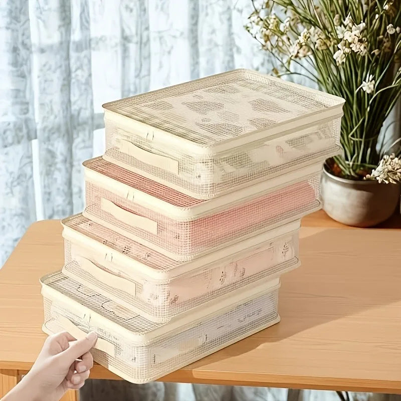 A stack of foldable bed sheet storage bags in various light pink and beige tones resting on a wooden table.