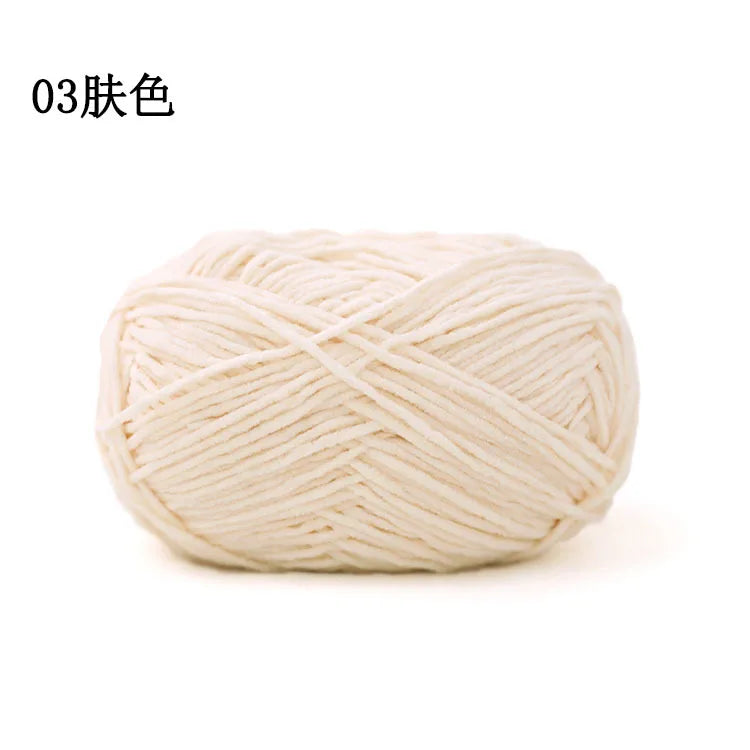 A ball of light beige matte chenille yarn for knitting and crochet