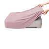 A pink polar fleece jacquard sofa seat cushion cover being held by a hand.