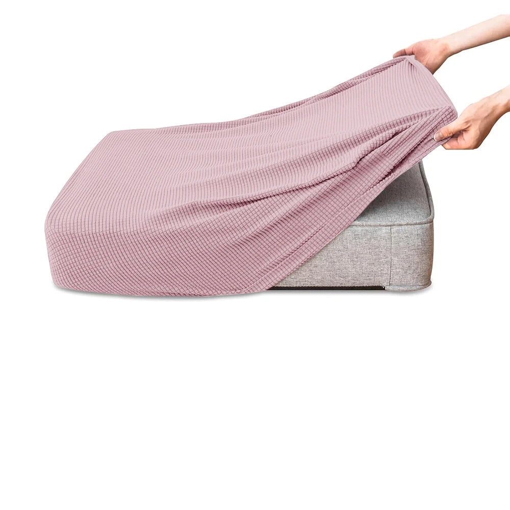 A pink polar fleece jacquard sofa seat cushion cover being held by a hand.