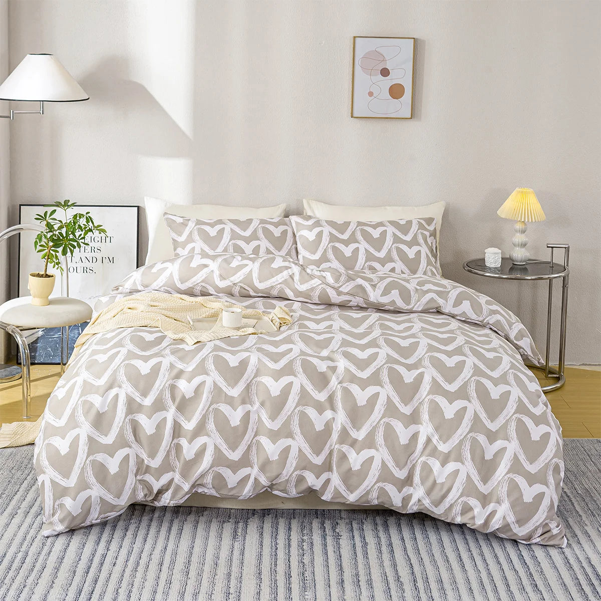 A light gray duvet cover with a white heart print is displayed on a bed in a bright room.