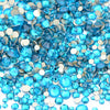 A pile of blue and clear glass rhinestones for DIY crafts