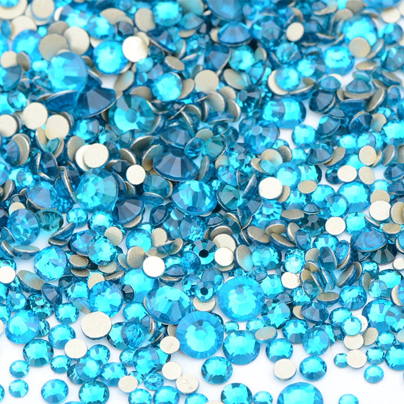 A pile of blue and clear glass rhinestones for DIY crafts