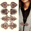 A set of vintage bronze zinc alloy sweater clips in various decorative styles.