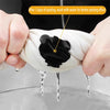 Hands are placing a black fabric repair patch onto a white garment, with water dripping from the patch.