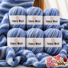 A set of three balls of blue gradient alpaca wool yarn labeled Fancy Wool for knitting and crochet projects.