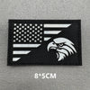 Black embroidered patch featuring a white American flag and an eagle silhouette on a gray background.