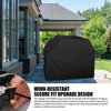 A black wind-resistant BBQ grill cover is shown next to a house exterior, highlighting its adjustable drawstring cords and ho