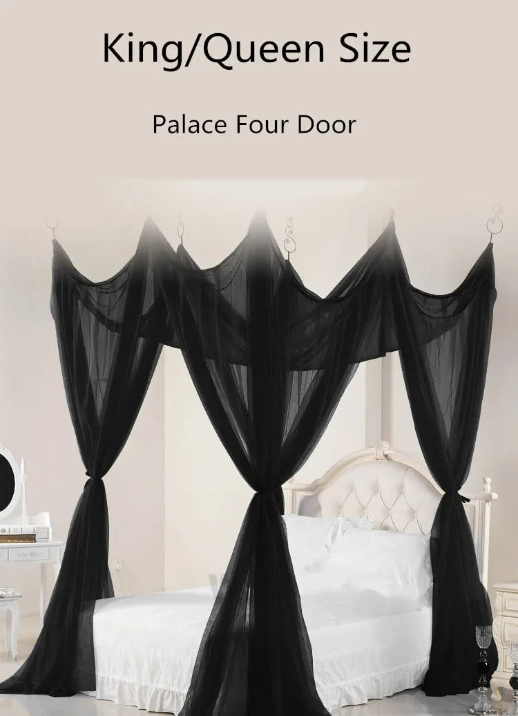 Black sheer mosquito netting draped as a four-door curtain over a white bed.