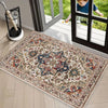 A rectangular retro floral area rug with blue, red, and cream patterns is displayed on a light wood floor near a glass door.
