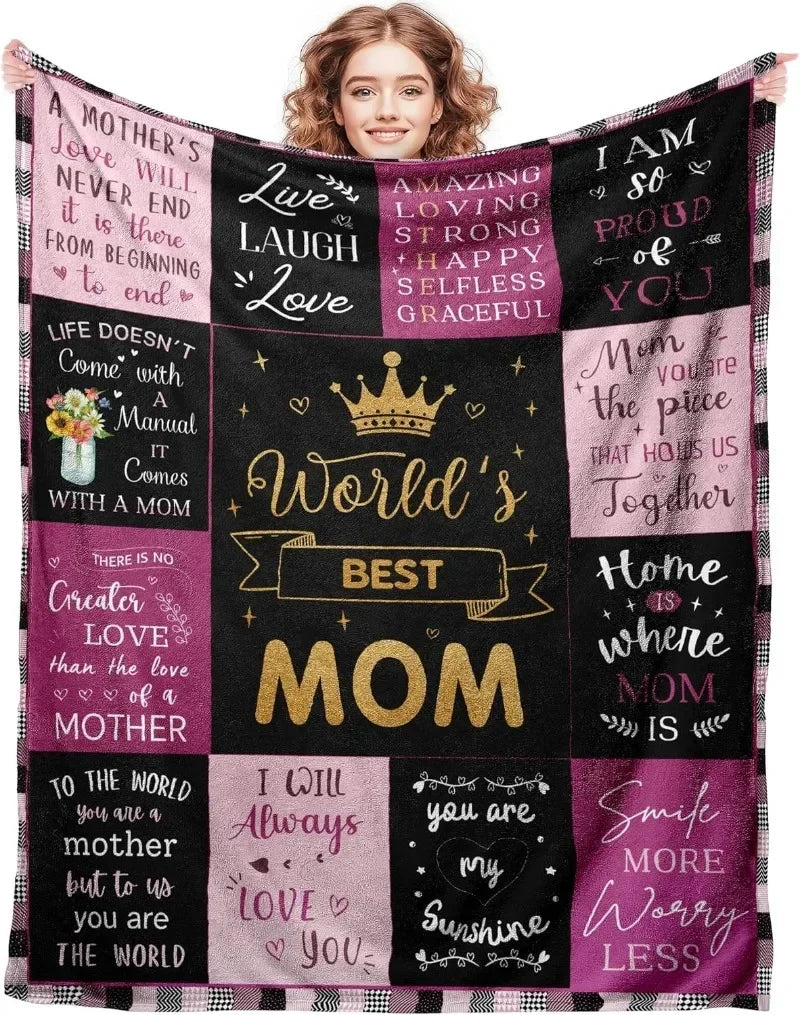 A black and pink knit blanket featuring inspirational quotes about motherhood and love.